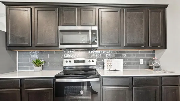 a kitchen with stainless steel appliances granite countertop a sink a stove and a refrigerator