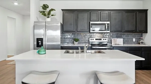 a kitchen with stainless steel appliances granite countertop a stove and a microwave