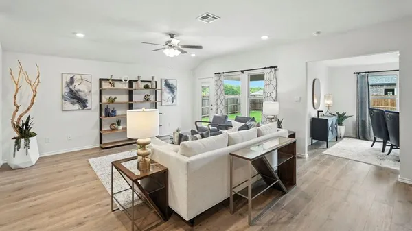 a kitchen with stainless steel appliances kitchen island granite countertop a sink refrigerator and cabinets