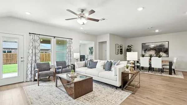 a living room with furniture and wooden floor