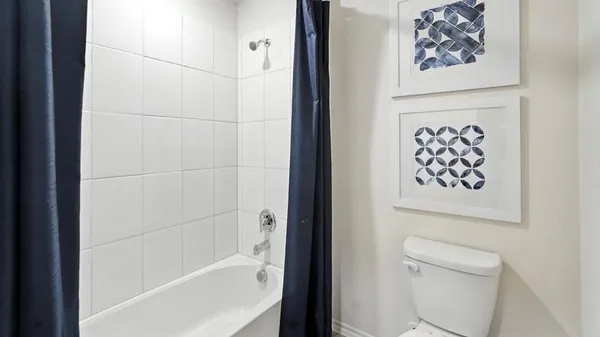 a bathroom with a shower and a toilet