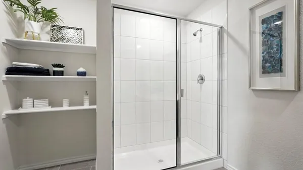 a living room with furniture kitchen view and a wooden floor