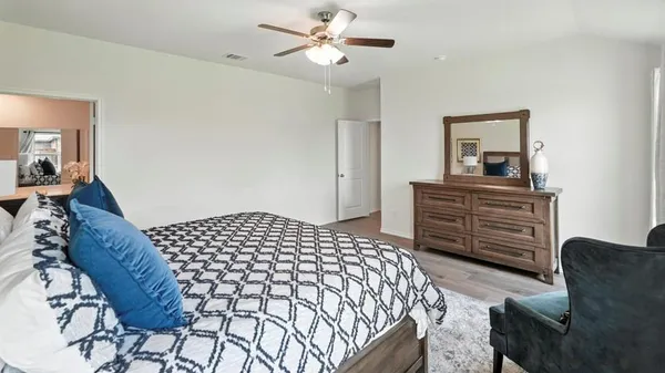 a bedroom with a bed mirror and window