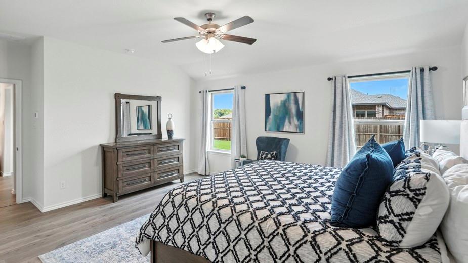 1911 Reveille Way Terrell, TX 75160 - Photo 25 of 39 Bedroom with vaulted ceiling, light wood finished floors, and a ceiling fan
