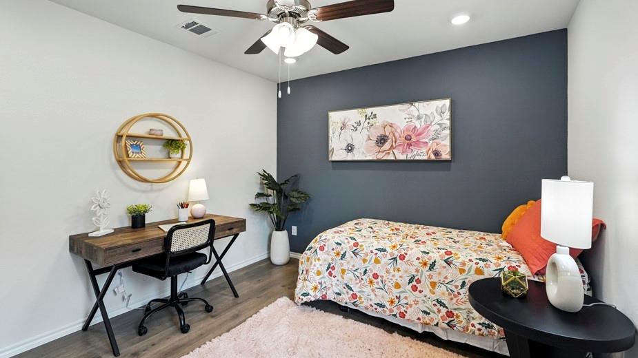 1911 Reveille Way Terrell, TX 75160 - Photo 27 of 39 Bedroom with wood finished floors, a ceiling fan, an accent wall, recessed lighting, and an office area