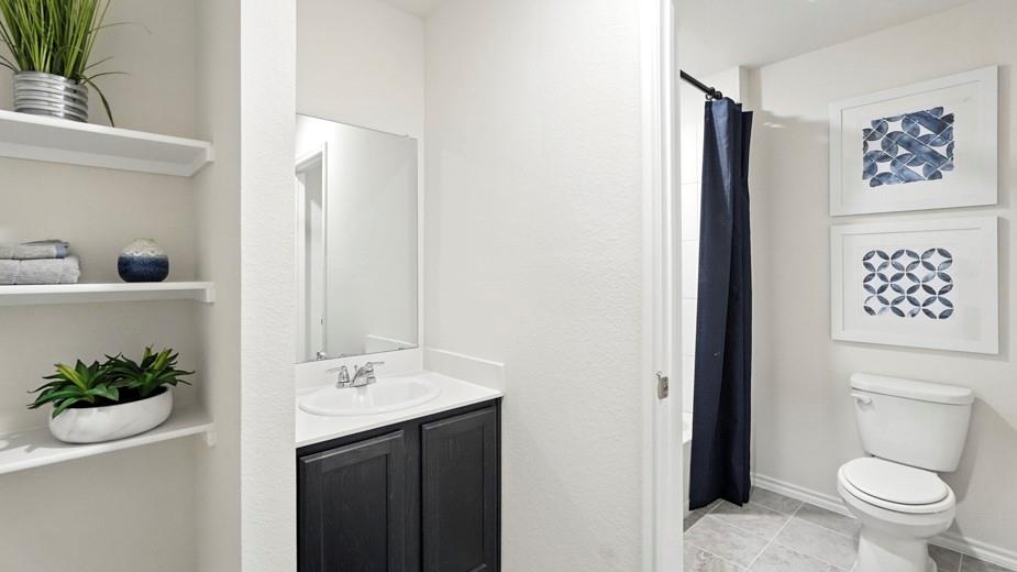 1911 Reveille Way Terrell, TX 75160 - Photo 3 of 39 Bathroom featuring vanity, a shower with shower curtain, and light tile patterned floors