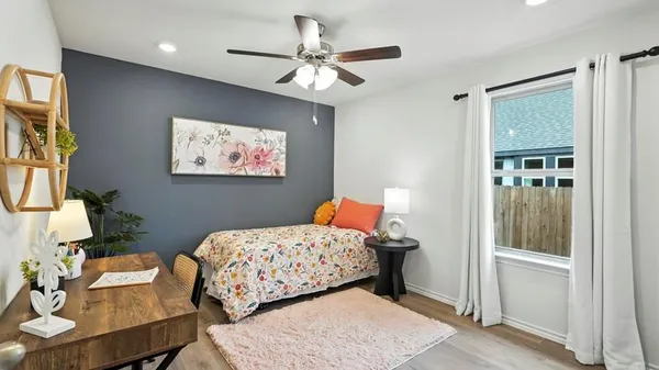 a bedroom with a bed and wooden floor
