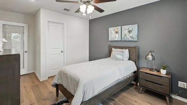 a view of a livingroom with furniture and a painting on the wall