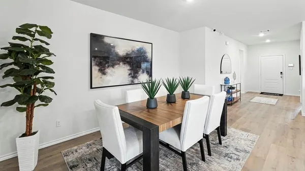 a dining room with furniture and wooden floor
