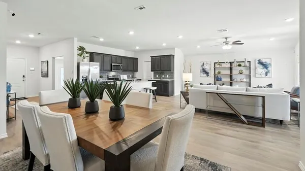 a dining table seating space a large window and stainless steel appliances