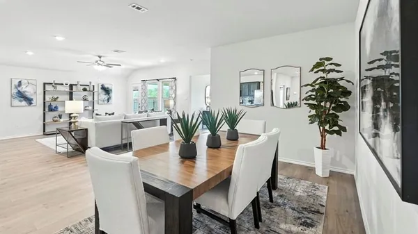 a dining room with furniture and wooden floor