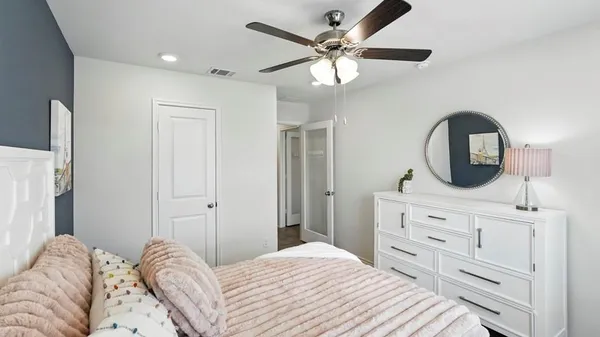 a bedroom with a large bed and a chandelier