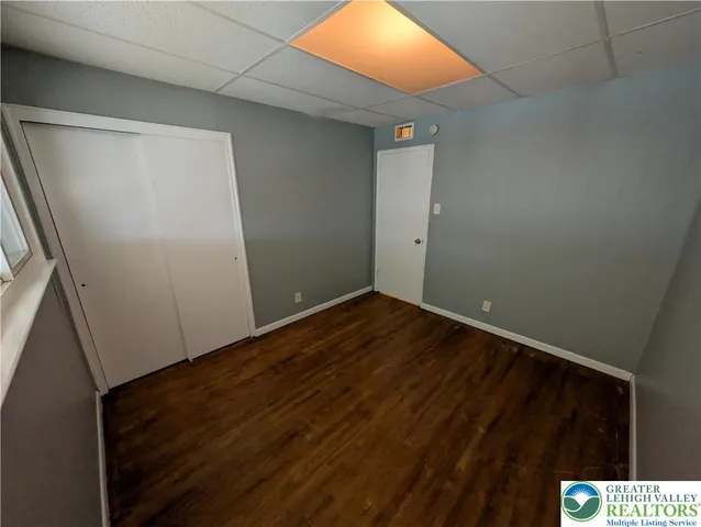 a view of small space with wooden floor and cabinet
