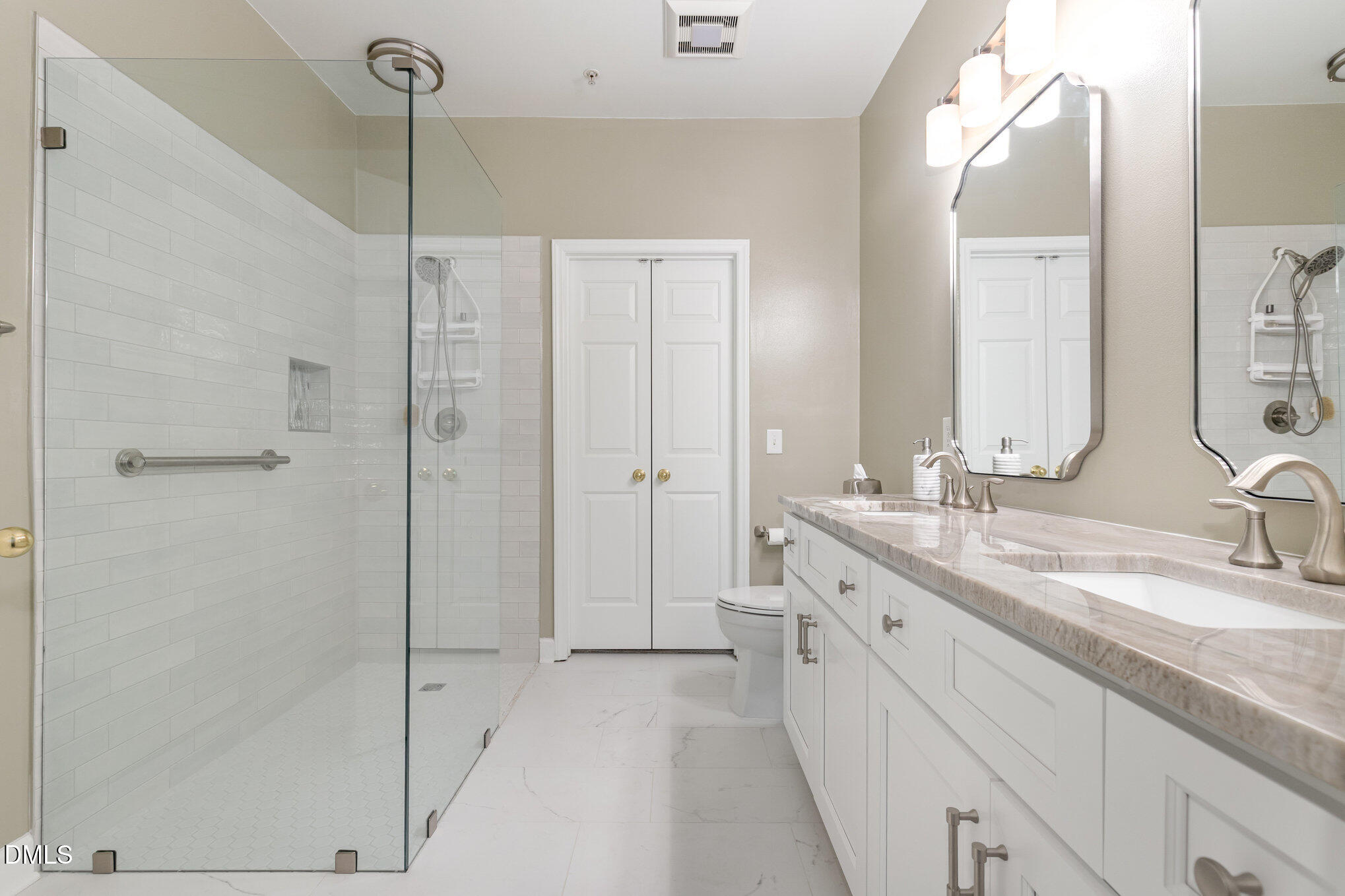 3121 Hemlock Forest Circle, Unit 203 Raleigh, NC 27612 - Photo 19 of 33 a spacious bathroom with a double sink shower and a mirror