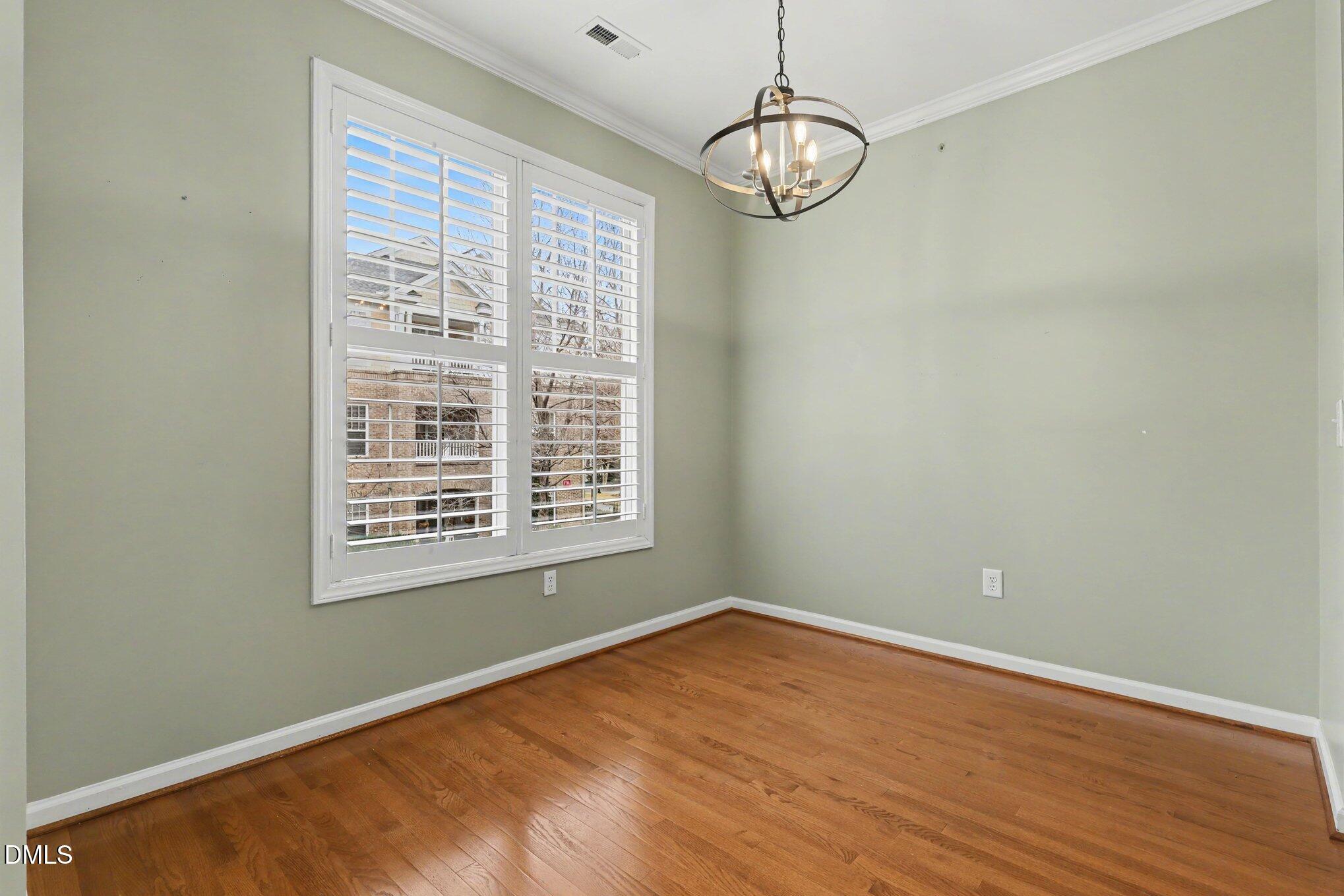3121 Hemlock Forest Circle, Unit 203 Raleigh, NC 27612 - Photo 4 of 33 a view of empty room with wooden floor and fan