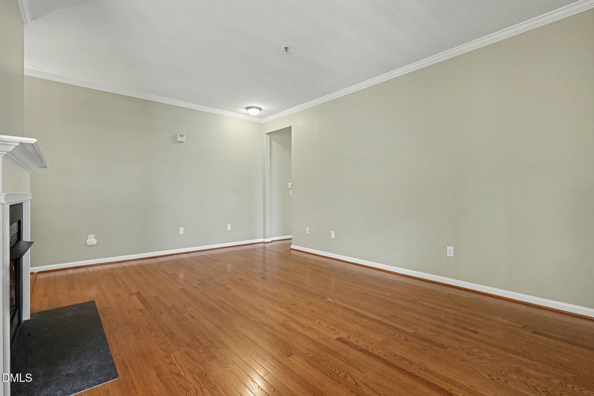 3121 Hemlock Forest Circle, Unit 203 Raleigh, NC 27612 - Photo 6 of 33 a view of an empty room with wooden floor