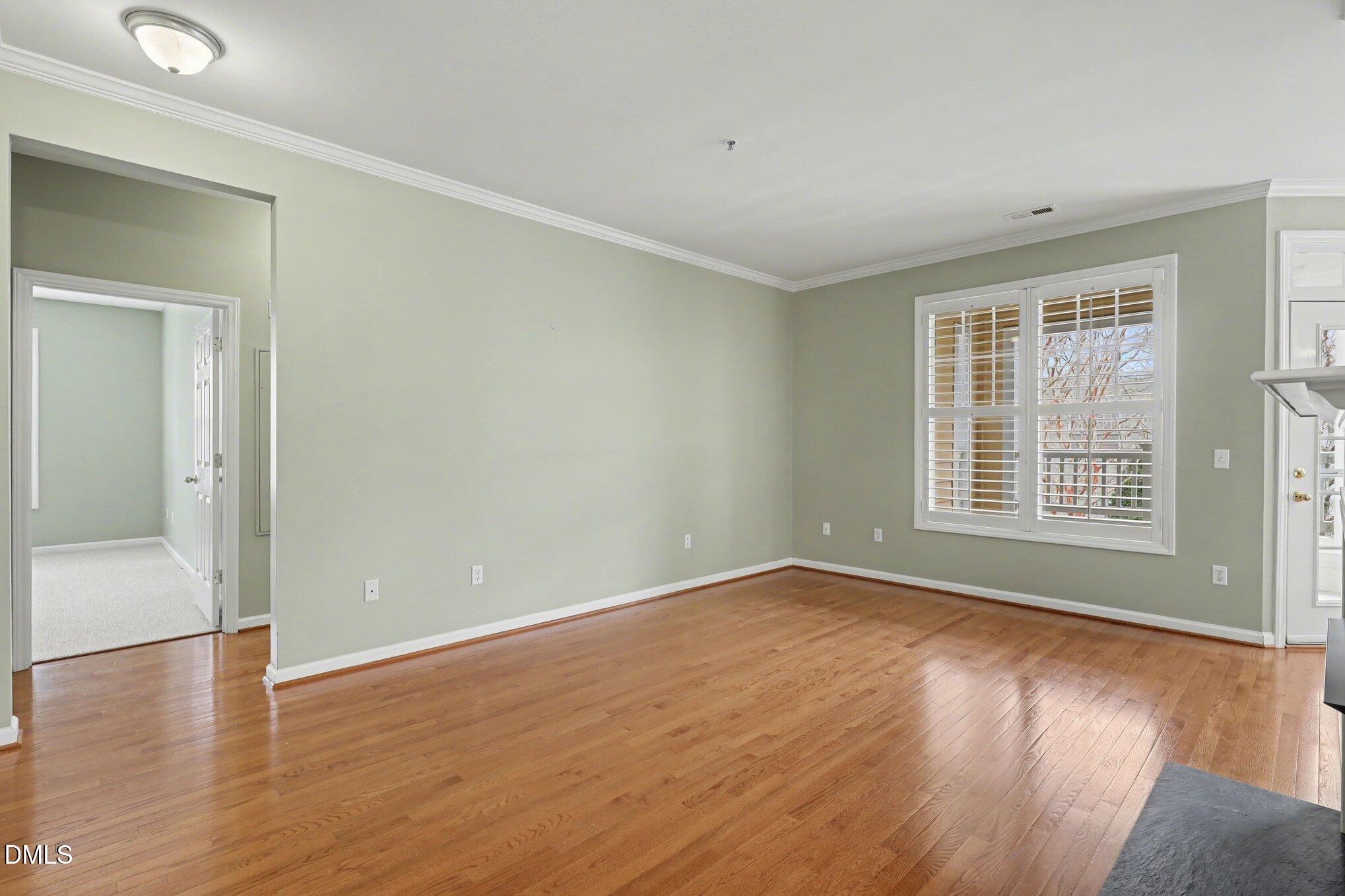 3121 Hemlock Forest Circle, Unit 203 Raleigh, NC 27612 - Photo 8 of 33 a view of a room with wooden floor and windows