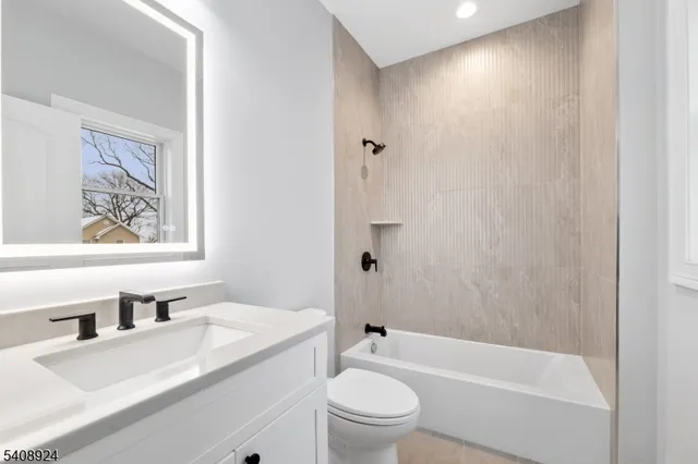 a bathroom with a sink a toilet and a bathtub