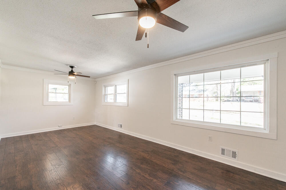 335 Indian Trail Augusta, GA 30907 - Photo 3 of 24 a view of an empty room with wooden floor and a window