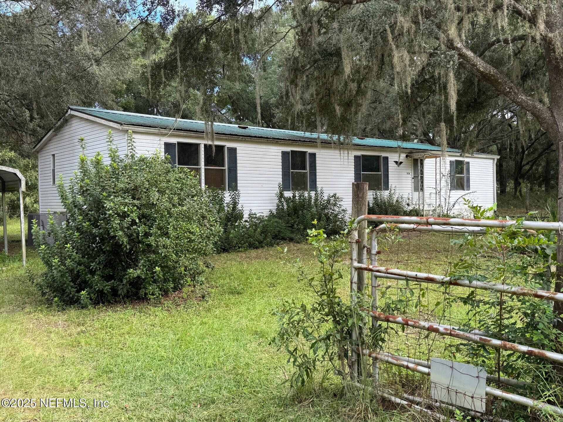 910 O Farrell Avenue Interlachen, FL 32148 - Photo 14 of 19 a backyard of a house with yard and outdoor seating