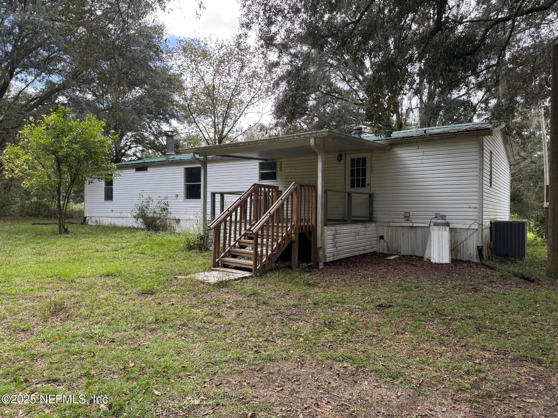910 O Farrell Avenue Interlachen, FL 32148 - Photo 16 of 19 a view of a house with a yard and a large tree