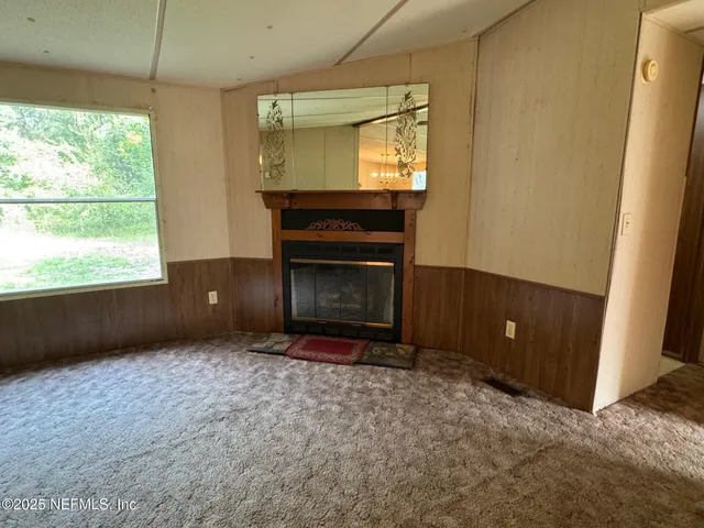 a living room with a fireplace and a large window