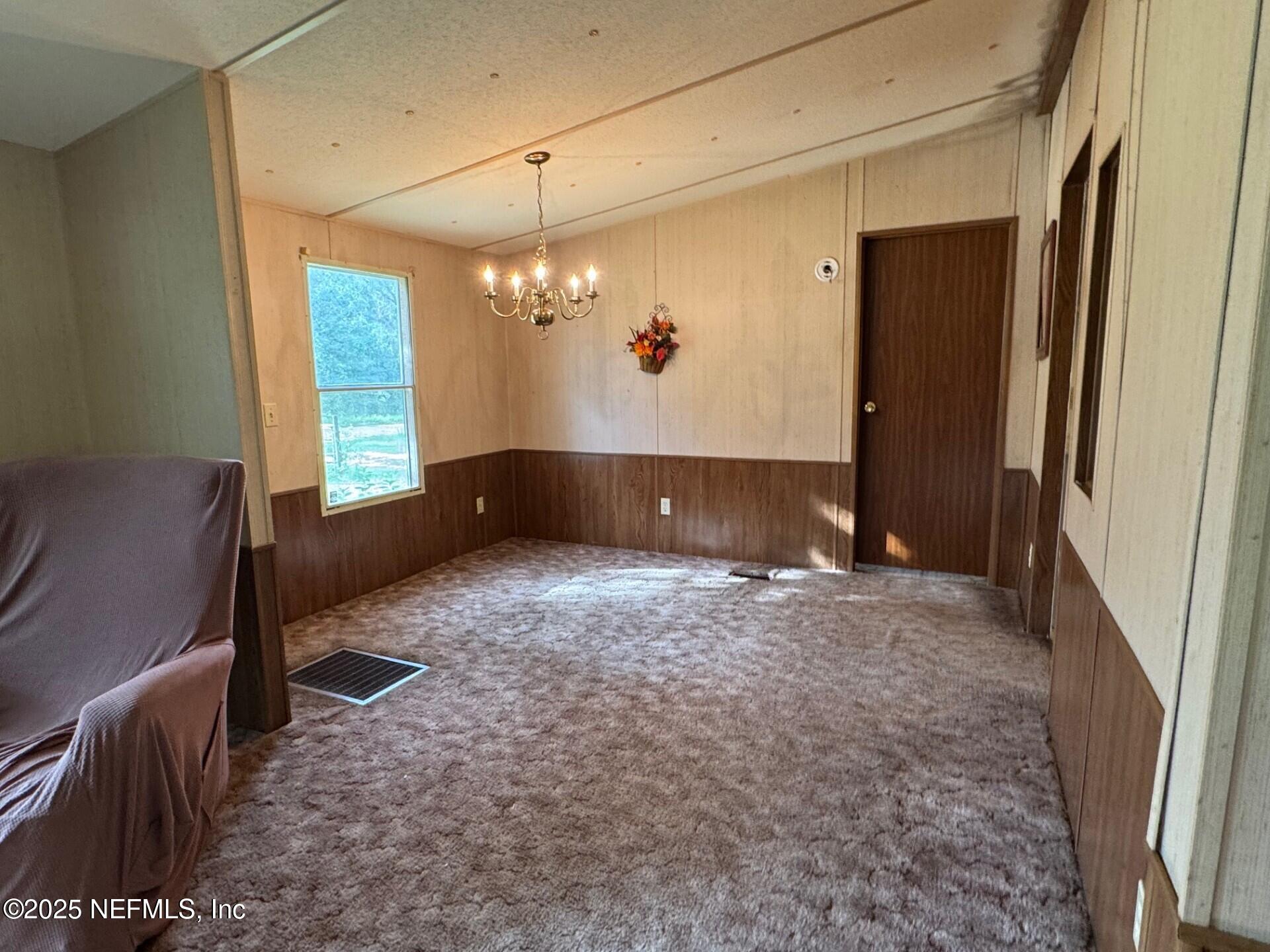 910 O Farrell Avenue Interlachen, FL 32148 - Photo 4 of 19 a view of a livingroom with furniture and chandelier