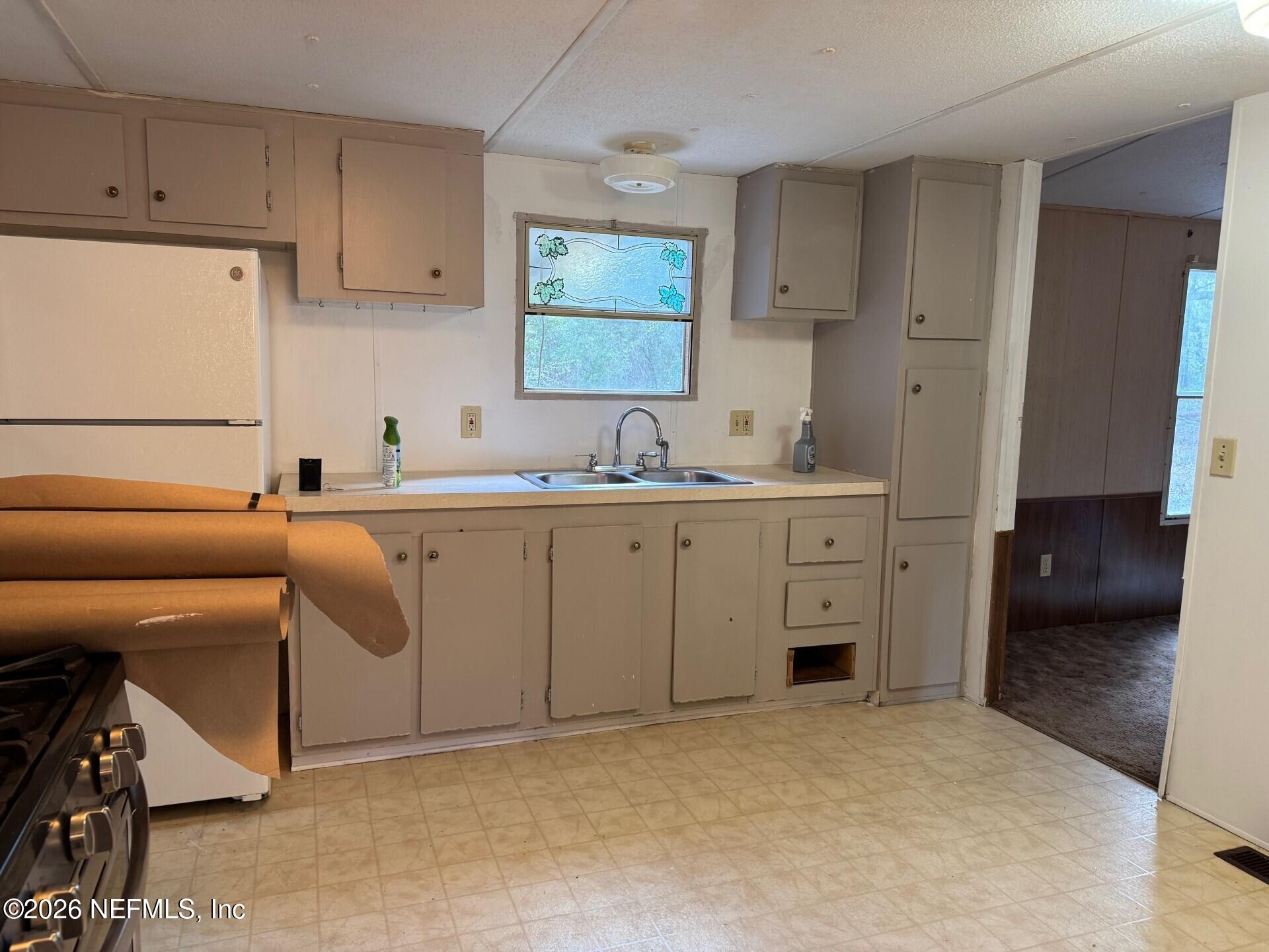 910 O Farrell Avenue Interlachen, FL 32148 - Photo 7 of 19 a kitchen with a sink cabinets and window