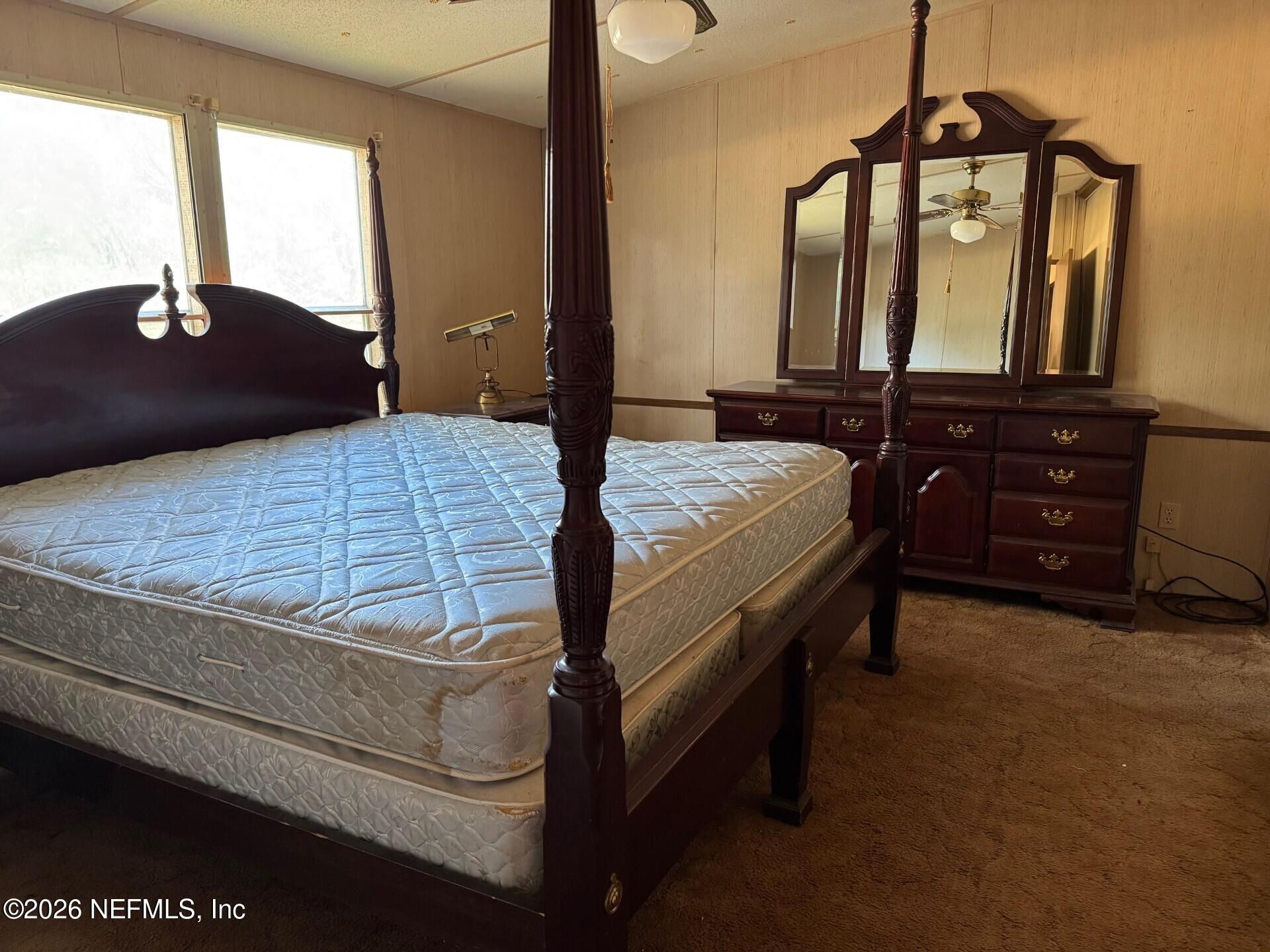 910 O Farrell Avenue Interlachen, FL 32148 - Photo 8 of 19 a bedroom with a bed a dresser and mirror