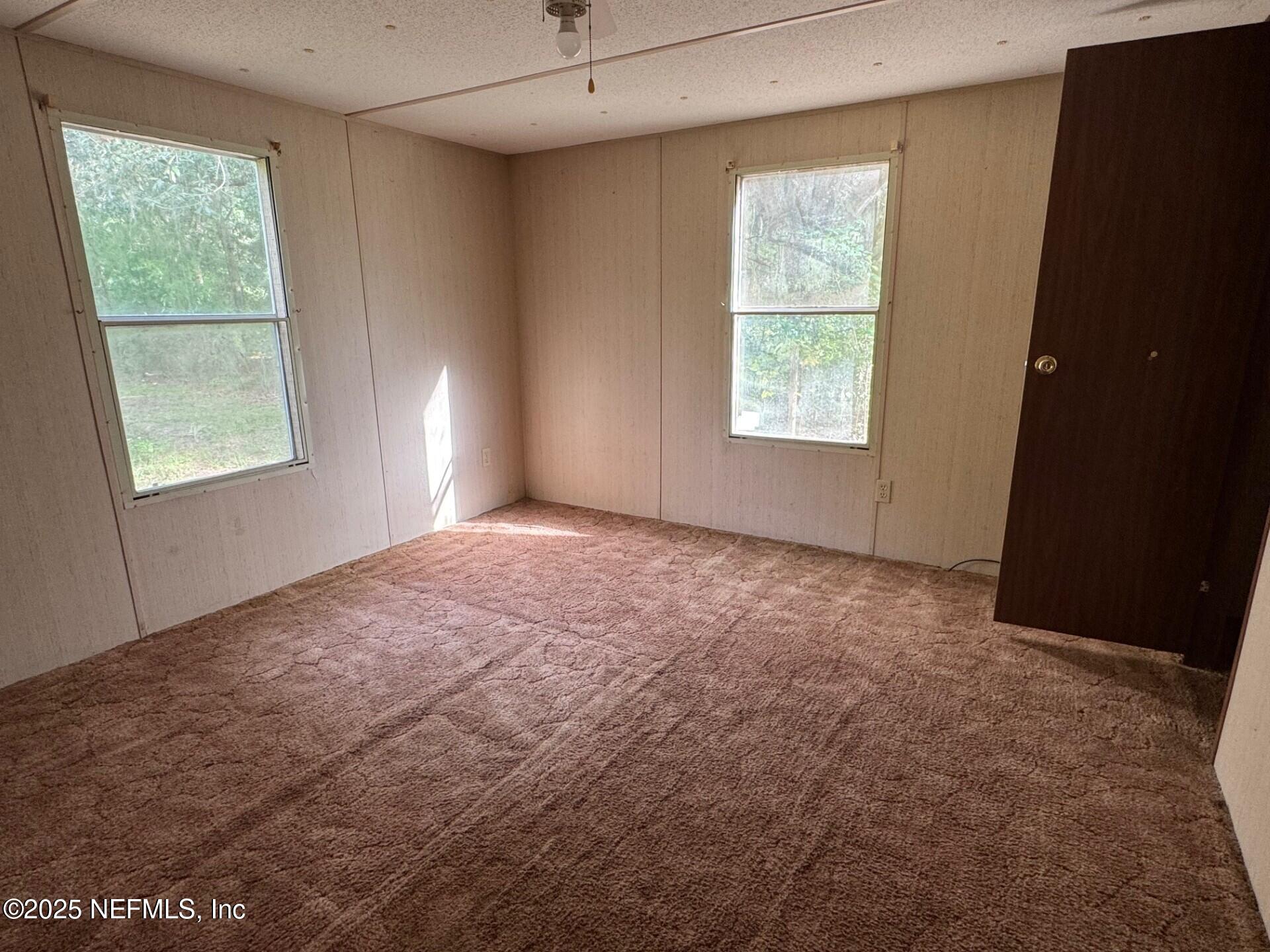 910 O Farrell Avenue Interlachen, FL 32148 - Photo 10 of 19 an empty room with windows