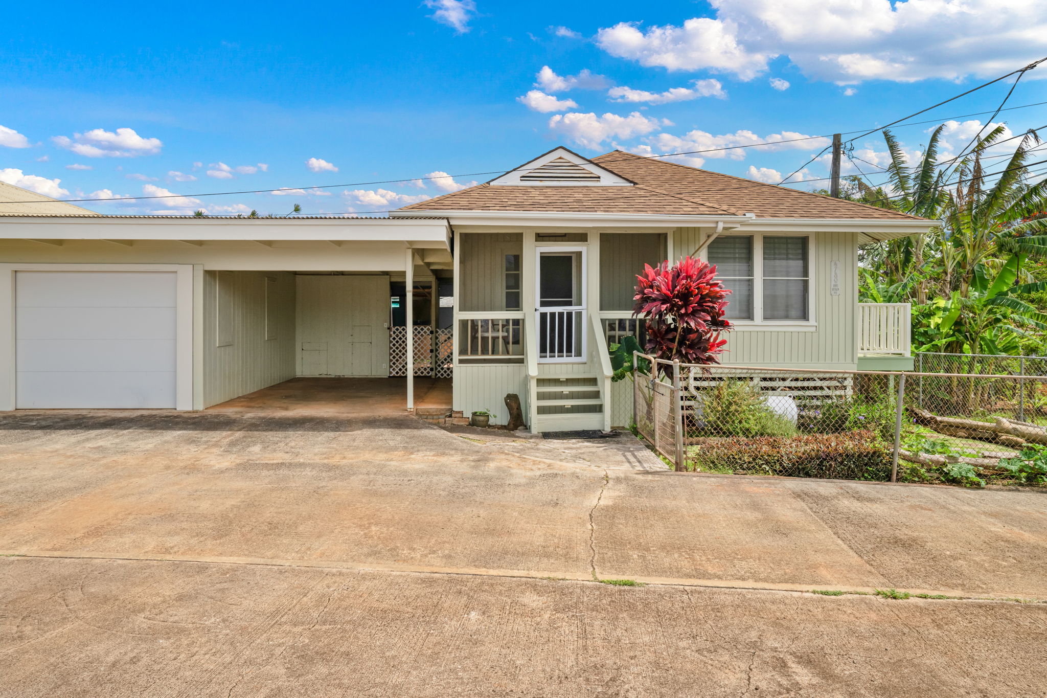 4780 Iiwi Road, Unit 1 Kapaa, HI 96746 - Photo 3 of 24 front view of a house with a garden