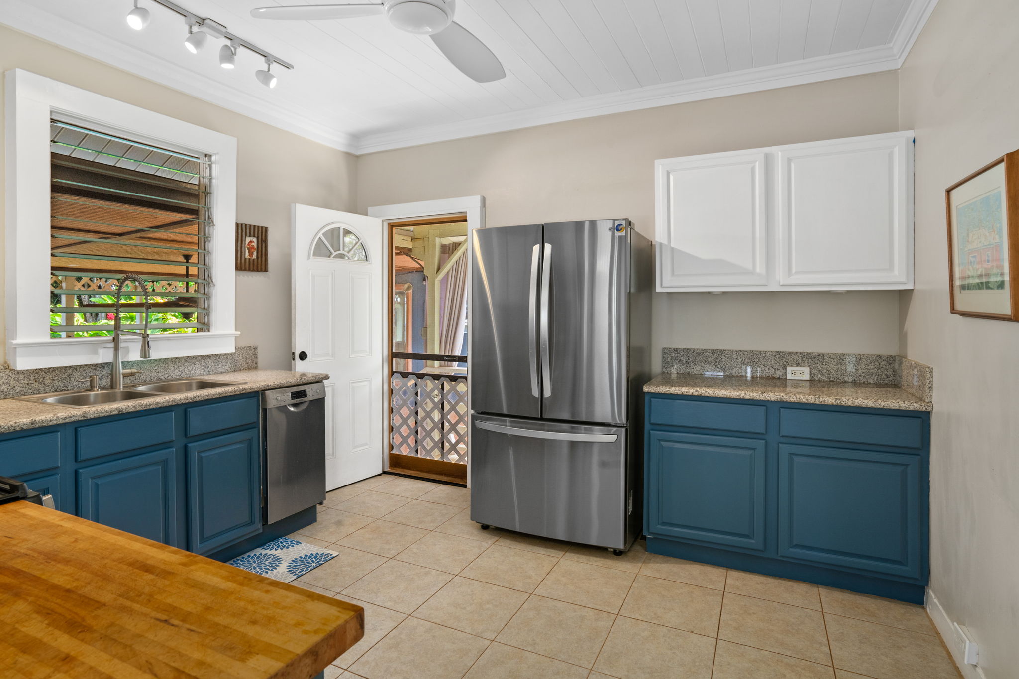 4780 Iiwi Road, Unit 1 Kapaa, HI 96746 - Photo 6 of 24 a kitchen with stainless steel appliances granite countertop a refrigerator and a sink