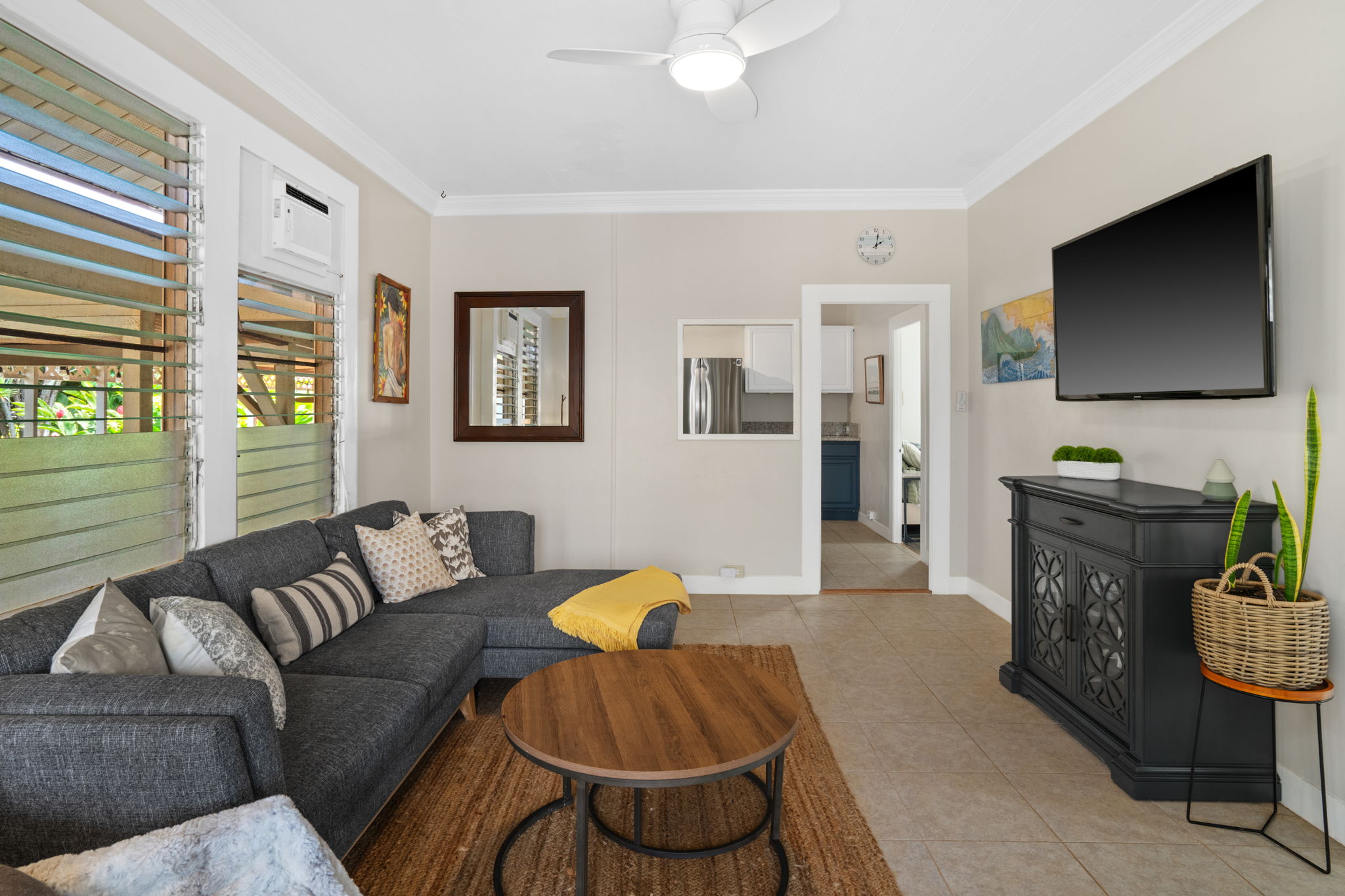 4780 Iiwi Road, Unit 1 Kapaa, HI 96746 - Photo 8 of 24 a living room with furniture a flat screen tv and a window