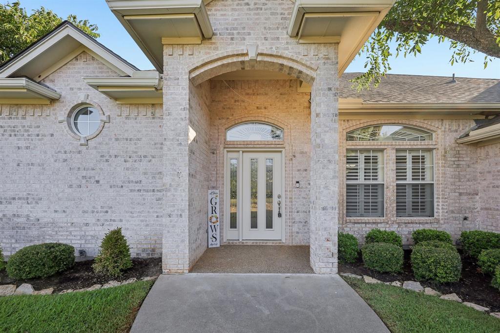 5409 Wedgefield Road Granbury, TX 76049 - Photo 3 of 39 Brick exterior with an arched entryway, transom window, and circular window