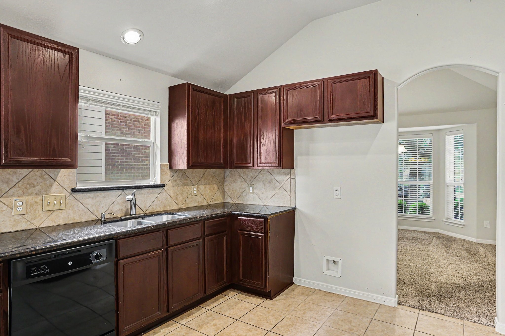 25222 Ginger Ranch Drive Katy, TX 77494 - Photo 8 of 33 Another view of the kitchen leading into the dining room through an arched opening.