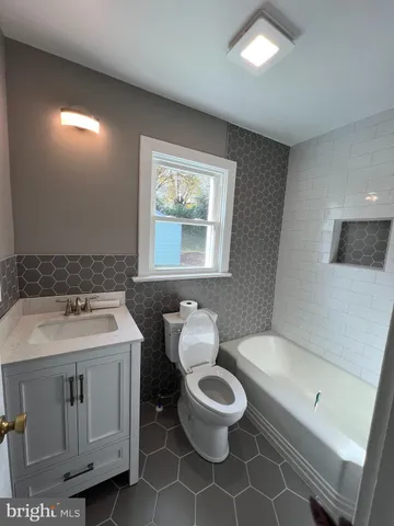 a bathroom with a shower toilet and sink