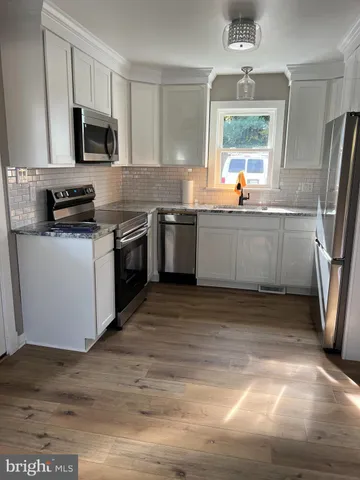 a kitchen with a sink stove and refrigerator
