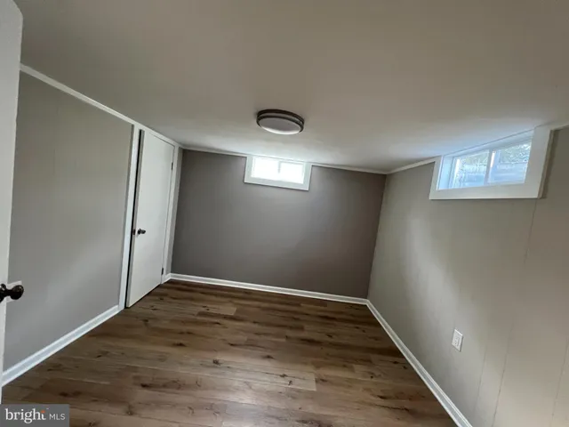 a kitchen with wooden floors and white stainless steel appliances