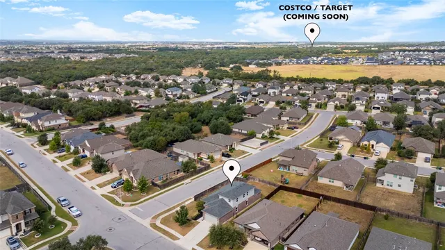 an aerial view of residential house with outdoor space and parking