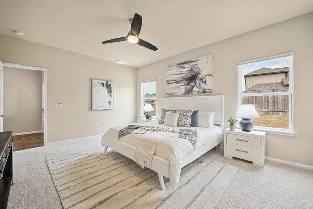 a bedroom with a large bed and a window