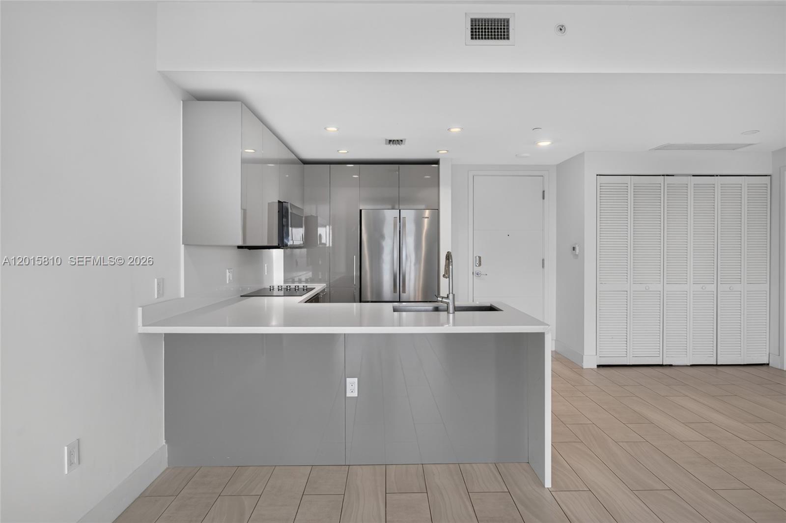 2000 Metropica Way, Unit 1902 Sunrise, FL 33323 - Photo 7 of 40 a large kitchen with stainless steel appliances a sink and a refrigerator