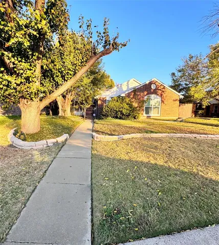 a view of a big yard with an ocean view