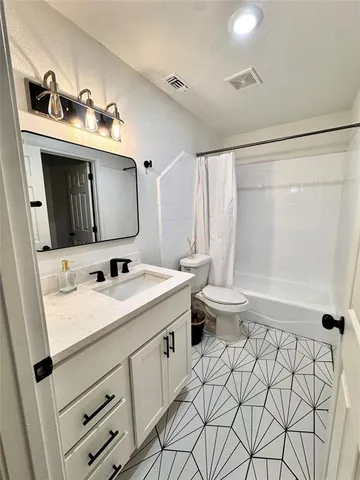 a bathroom with a sink a toilet and mirror