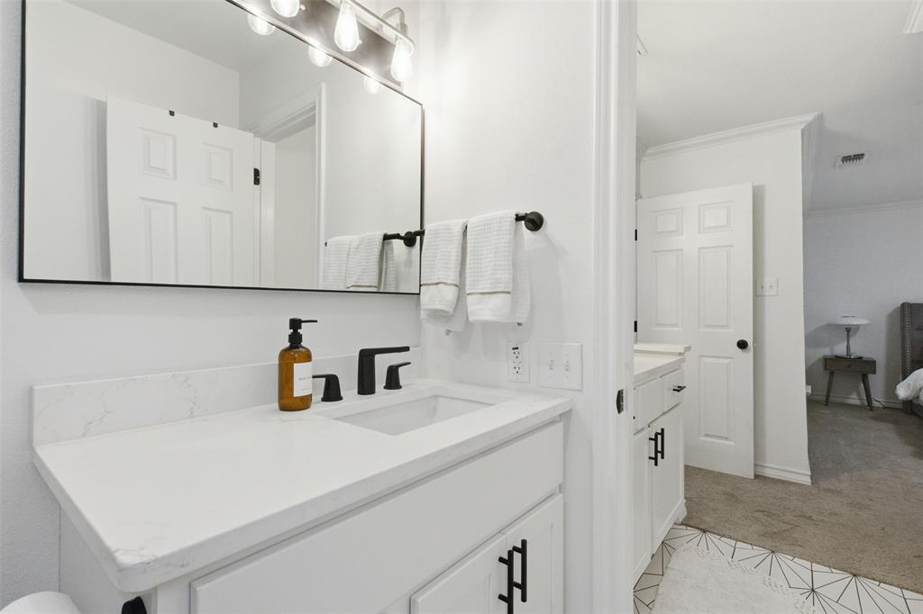 9112 Shiloh Road Dallas, TX 75228 - Photo 14 of 23 a bathroom with a sink and a mirror