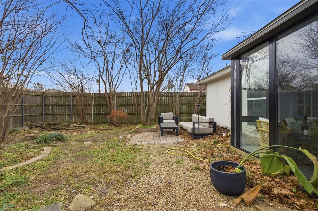 9112 Shiloh Road Dallas, TX 75228 - Photo 21 of 23 a view of a backyard with table and chairs potted plants and large tree