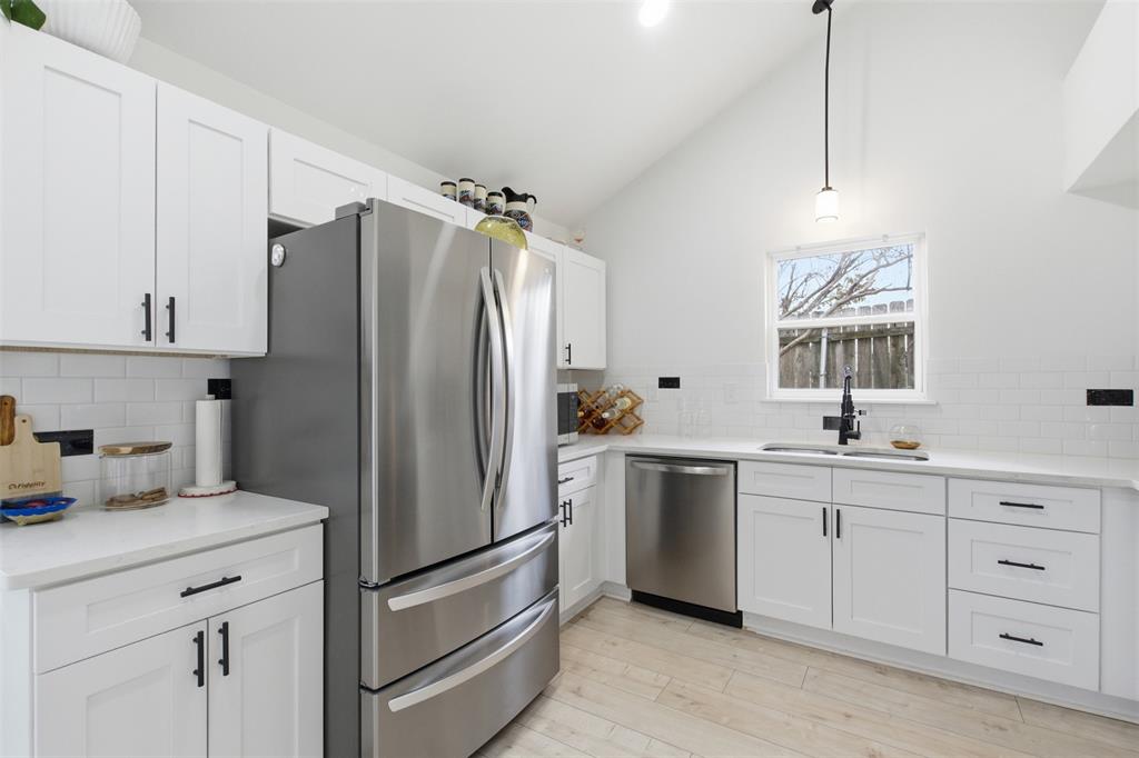 9112 Shiloh Road Dallas, TX 75228 - Photo 4 of 23 a kitchen with white cabinets and stainless steel appliances
