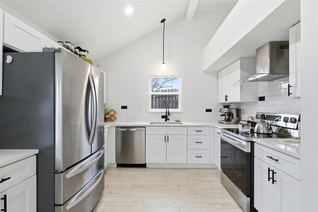 9112 Shiloh Road Dallas, TX 75228 - Photo 5 of 23 a kitchen with stainless steel appliances a refrigerator sink and white cabinets