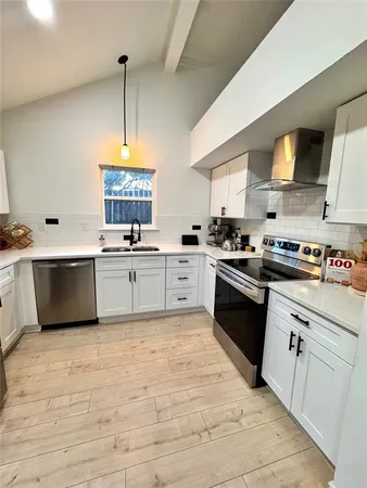 a kitchen with a sink window and cabinets