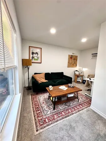 a living room with furniture rug and window