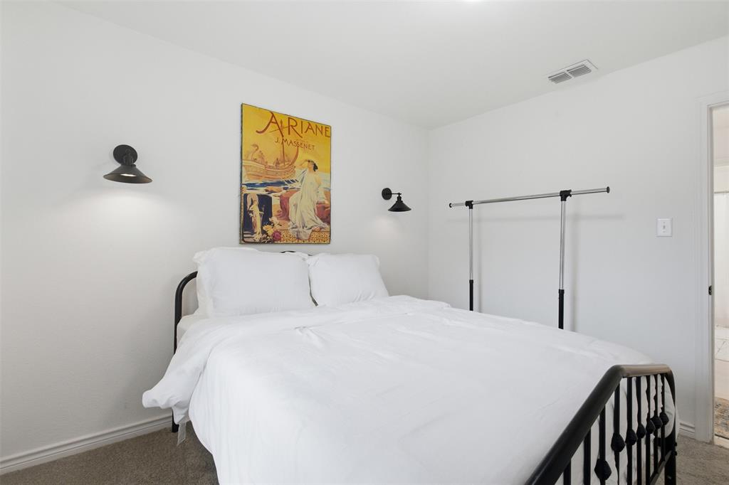 9112 Shiloh Road Dallas, TX 75228 - Photo 10 of 23 a bedroom with a bed and a painting on the wall